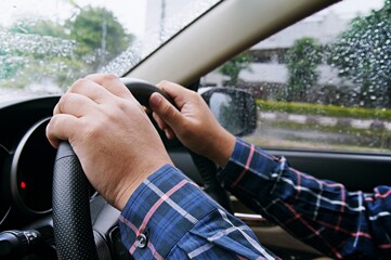 Businessman driving with both hands on steering wheel selective focus. safety driving concept.