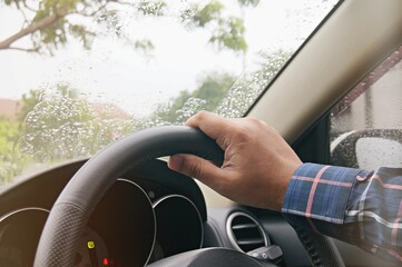 Businessman driving with both hands on steering wheel selective focus. safety driving concept.