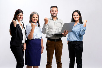 Young and confident indian business people group standing on white background.