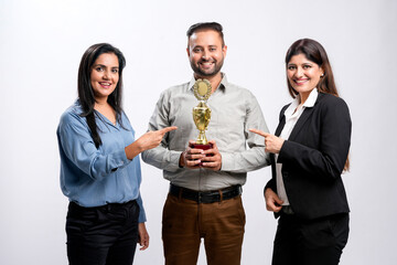 Young successful businessman or employee receiving award with support staff.