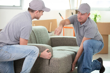 two contractor employees moving personal belongings