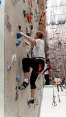 the girl on the climbing wall. sports concept