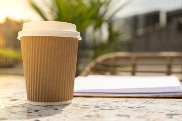 Unrecognizable Young woman study in beach resort. Drinking coffee from paper cup. Student making homework Female hands writing on notebook gratitude journal self reflection self discovery in Co