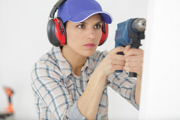 woman construction worker working with screwdriver