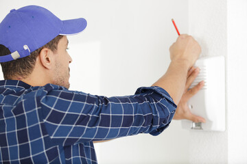 handsome young electrician repairing intercom © auremar