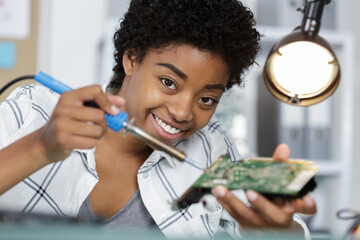 computer technician using soldering iron