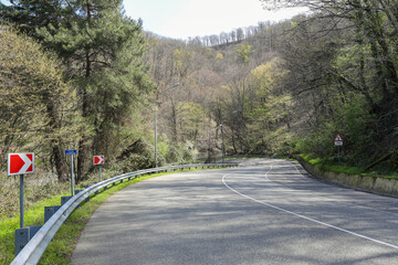 Highway, asphalt road in a picturesque mountainous area in early spring. Russia, Sochi.