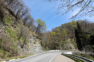 Highway, asphalt road in a picturesque mountainous area in early spring. Russia, Sochi.