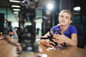 Happy caucasian kid girl learn with electric arm robot in modern classroom	