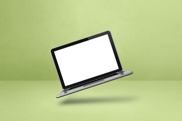 Floating computer laptop isolated on green. Horizontal background