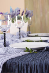 Luxurious table decor for fine dining. Beautiful blurred background. Preparing for a festive lunch or dinner. Copy space