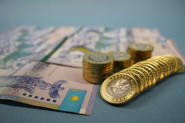 Almaty, Kazakhstan - 04.05.2023 : Coins and banknotes of Kazakhstani tenge are laid out on the table.