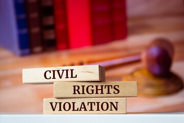 Wooden blocks with words 'CIVIL RIGHTS VIOLATION'. Legal concept