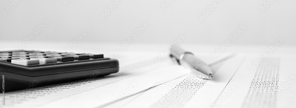 Poster calculator on financial statement and balance sheeet on desk of auditor. concept of accounting and a