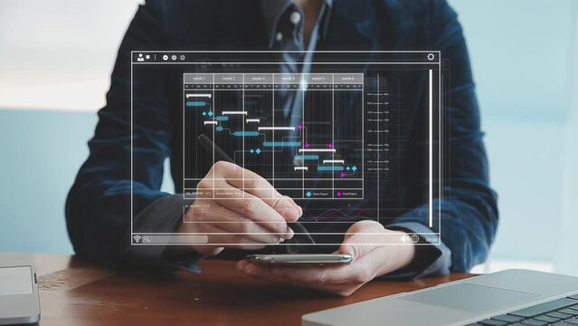 Project manager working with Gantt chart schedule to plan tasks and deliverables. Scheduling activities with a planning software, Corporate strategy for finance, operations, sales, marketing.