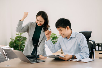 Obraz premium Portrait of success business people working together in home office. Couple teamwork startup concept.