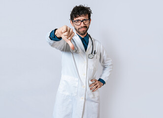 Doctor gesturing disapproval isolated. Unhappy doctor with thumb down isolated. Male doctor...