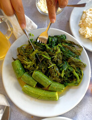 Boiled zucchini and herbs salad with olive oil, healthy Mediterranean vegan food.