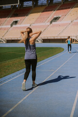 Two girls walking on a sports track at the stadium