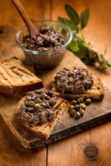 italian canape with liver pate over wood table