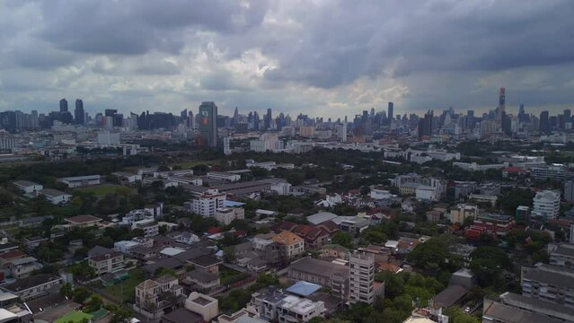 buildings of the suburb in the background cloudy sky line of the city. Spectacular aerial view flight 
Bangkok District ari, thailand 2022. panorama orbit drone
4k uhd cinematic footage.