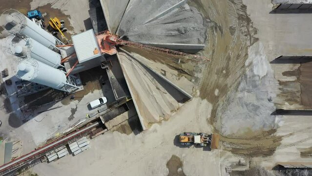 Aerial view of cement manufacturing plant. Working sand loading machines.