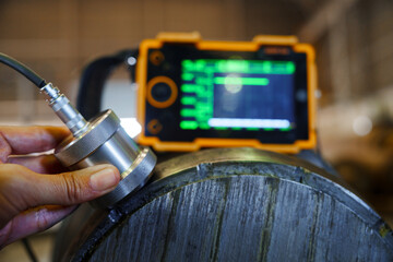 UT, Ultrasonic test to detect imperfection or defect in steel roller in the factory, NDT Inspection. © sakarin14
