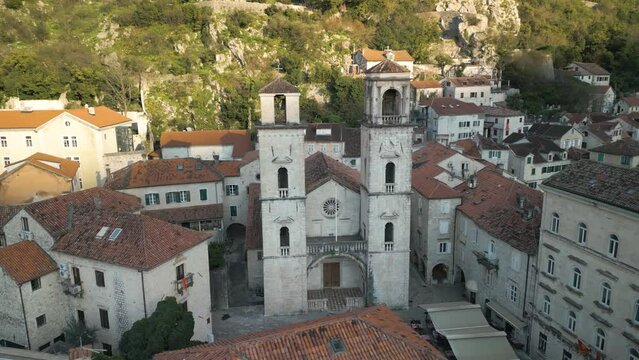 Drone panning shot of the high church towers of the St Tryphon cathedral in Kotor