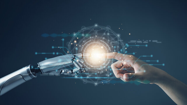 AI technology concept, Machine Learning, Robot hand touching human hand. to connect with global data refers to how humans can create and control artificial intelligence, AI innovation and technology.