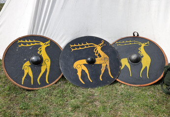 Medieval weapons, shields in knight camp at the festival of historical reconstruction