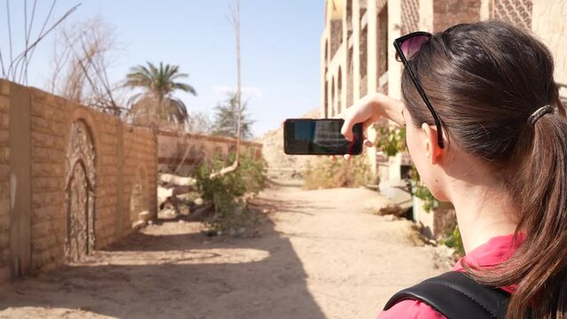 Girl taking a selfie in Egypt in front of an oriental gate