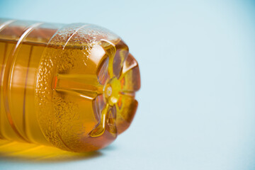 Apple juice in a plastic bottle on a blue background. Concept of earth day, zero waste and plastic...