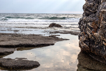 Rocky shore of the Aegean Sea in a cloudy day