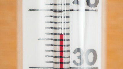 Glass thermometer shows normal body temperature of 36.6