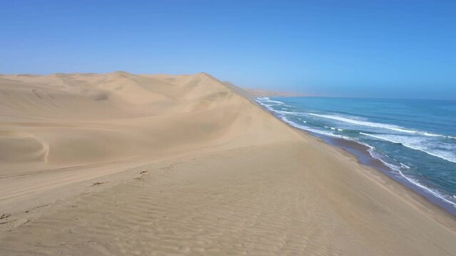 Pan on the Namib Desert meeting the Atlantic Ocean in the Skeleton Coast near Sandwich Harbour in Namibia, Africa.