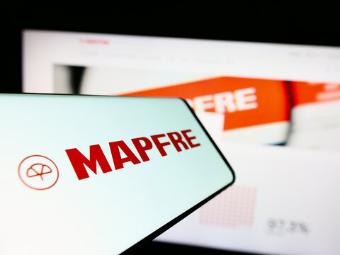 Stuttgart, Germany - 04-01-2023: Smartphone with logo of Spanish insurance company Mapfre SA on screen in front of business website. Focus on center-left of phone display.