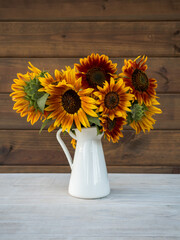Bouquet of sunflowers in white vase