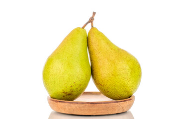 Two sweet pears on a wooden saucer, macro, isolated on white background.