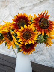 Close-up of sunflower bouquet in a white vase