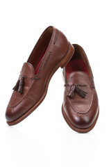 Pair of Traditional Formal Stylish Brown Pebble Grain Tassel Loafer Shoes On White Reflective Surface.