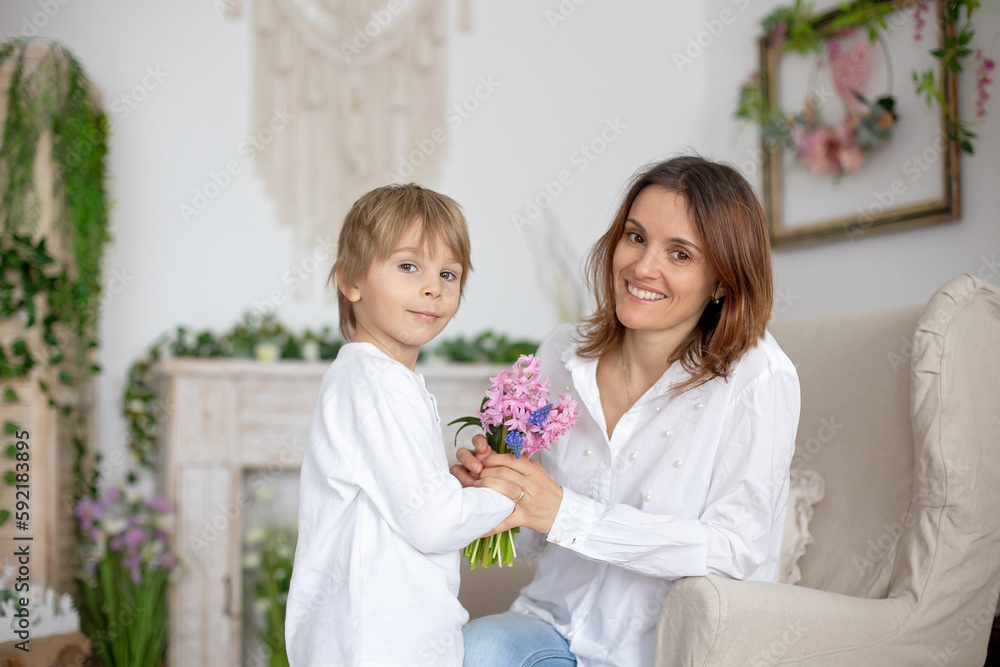 Poster Cute little boy, giving flowers to his mom for Mothers day.