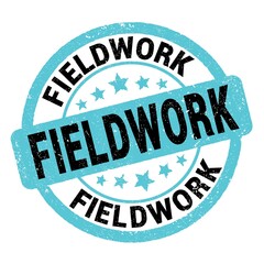 FIELDWORK text written on blue-black round stamp sign.