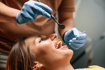 Looking at the aligner. Checking the condition. Woman in the stomatology clinic, visiting dentist