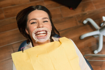 Young woman is in dental clinic. The aligner