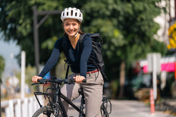 Asian woman bike to work In good weather
