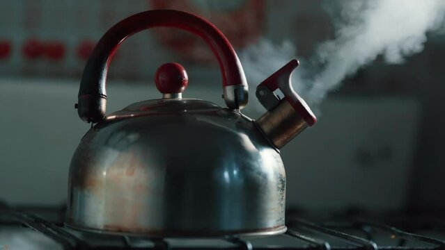 Whistling and boiling kettle with steam texture on beautiful bokeh background