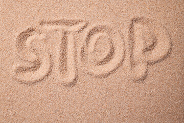 Sign of the Sands: Hand-Drawn STOP on Sandy Beach