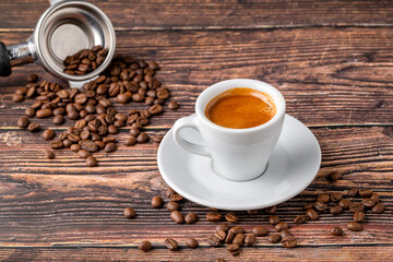 Fresh double espresso coffee together decorated with coffee beans on wooden table
