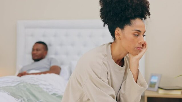 Anger, erectile dysfunction and marriage with a woman in the bedroom, upset about infertility or sex. Divorce, frustrated and fighting with a young female sitting on her bed feeling unhappy or angry