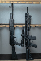 Two rifles in the armory.  Ar 15 with optical sight and ak74m.